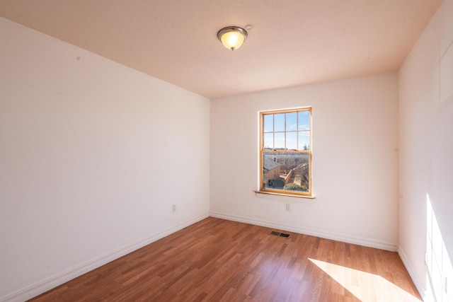 empty room featuring hardwood / wood-style floors