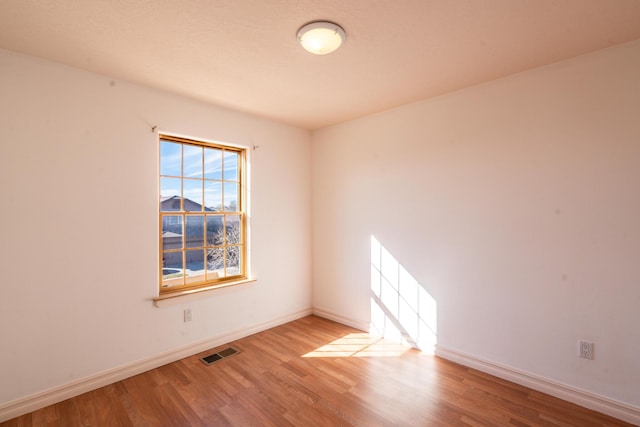 spare room with light hardwood / wood-style floors