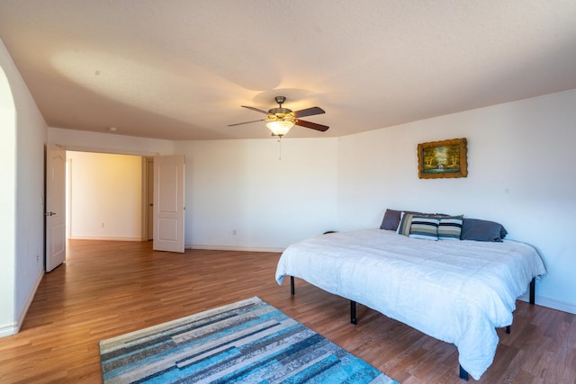 bedroom with ceiling fan and hardwood / wood-style floors