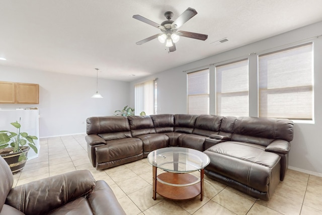 living room featuring light tile patterned floors and ceiling fan