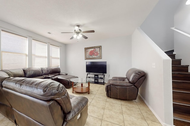 living room featuring light tile patterned flooring and ceiling fan