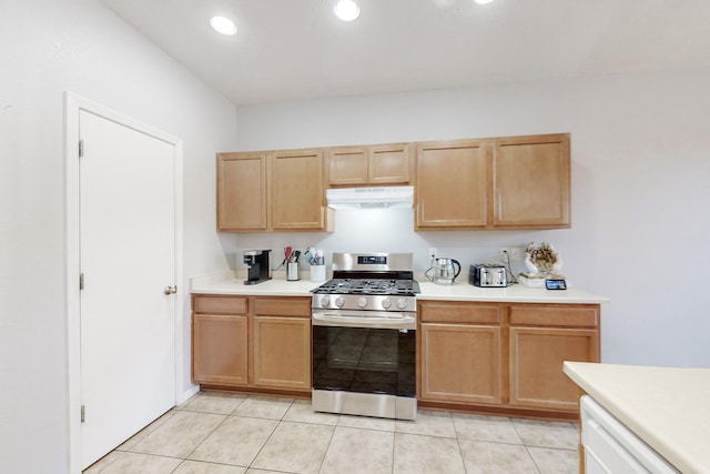 kitchen with light tile patterned flooring, dishwasher, and stainless steel range with gas stovetop