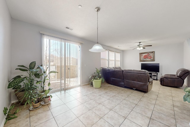 tiled living room with ceiling fan