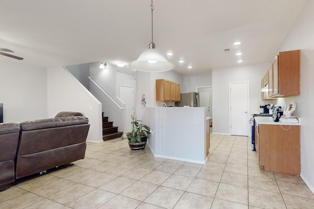 kitchen featuring stainless steel appliances, light tile patterned flooring, ceiling fan, and decorative light fixtures