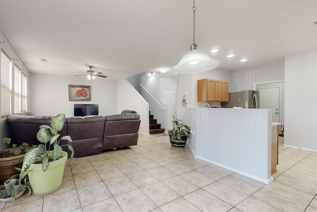 tiled living room featuring ceiling fan