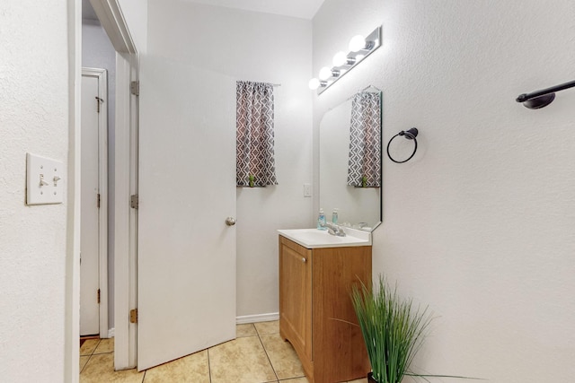 bathroom with tile patterned flooring and vanity