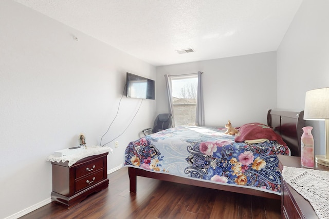 bedroom with dark hardwood / wood-style floors