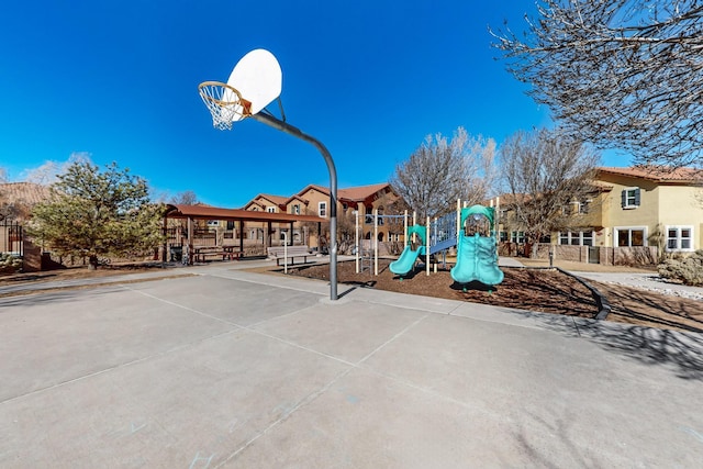 view of sport court with a playground