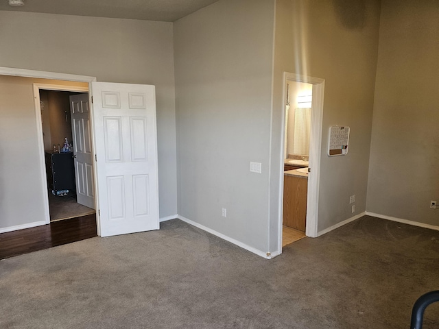 unfurnished bedroom featuring carpet flooring and ensuite bathroom