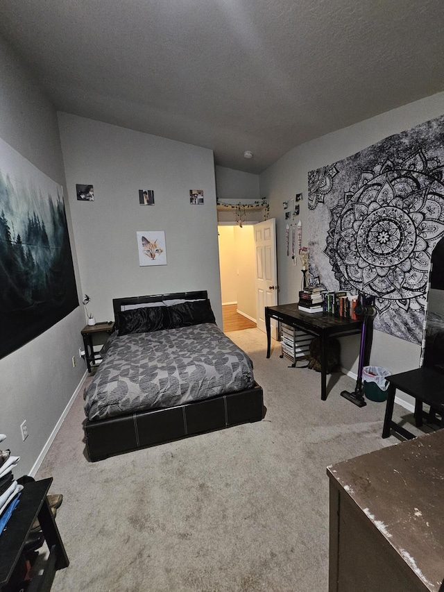 bedroom featuring carpet flooring and a textured ceiling