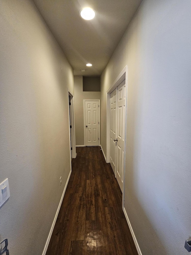 corridor with dark hardwood / wood-style floors