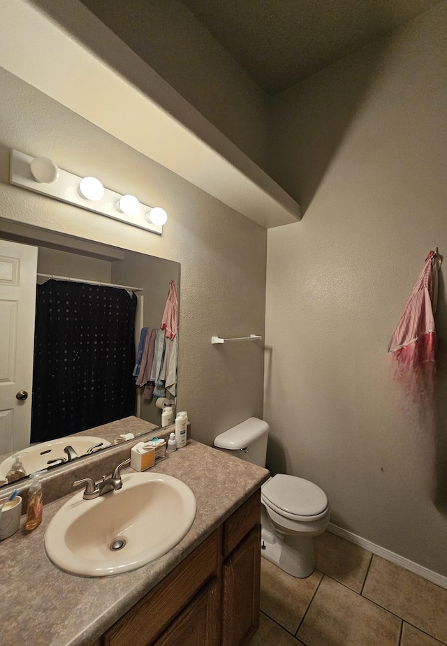 bathroom featuring tile patterned flooring, vanity, toilet, and a shower with shower curtain