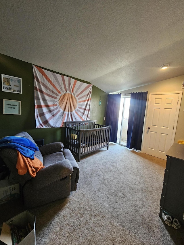 carpeted bedroom with a textured ceiling and vaulted ceiling