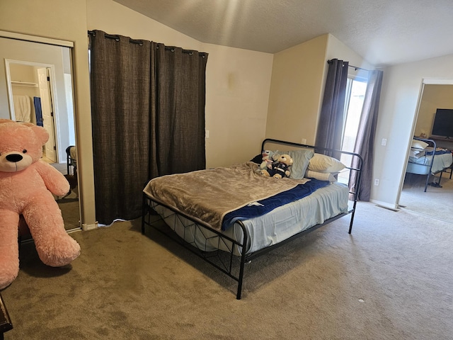 bedroom with lofted ceiling and carpet floors