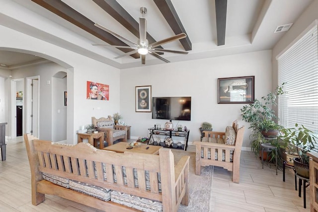 living room featuring beam ceiling and ceiling fan