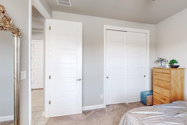 bedroom featuring light carpet and a closet