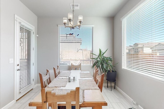 dining room with a healthy amount of sunlight and a chandelier