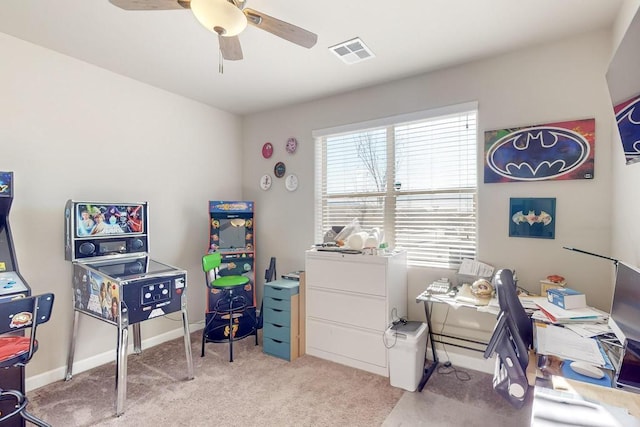 office space featuring light carpet and ceiling fan