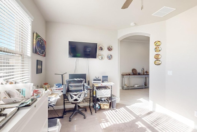 home office with ceiling fan and light carpet