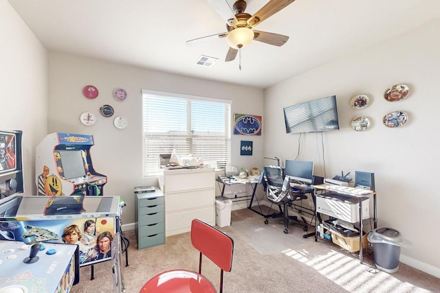 carpeted office space featuring ceiling fan