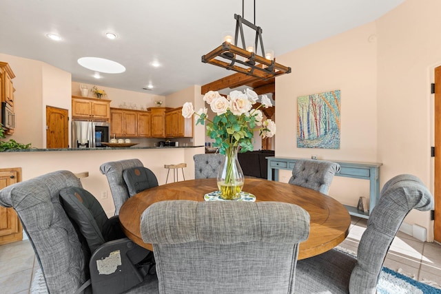 dining space featuring light tile patterned floors, a notable chandelier, and recessed lighting