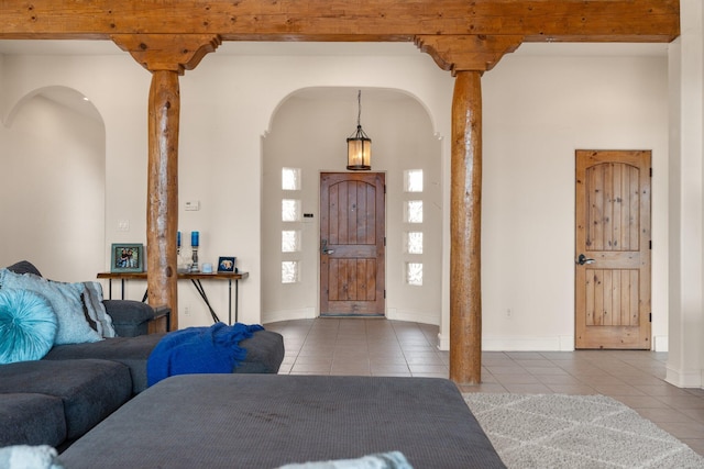 tiled foyer entrance with baseboards