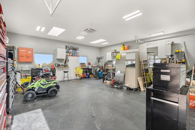 garage with a workshop area and visible vents