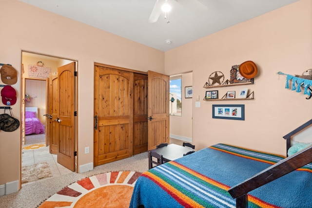 bedroom featuring a ceiling fan, a closet, baseboards, and carpet flooring