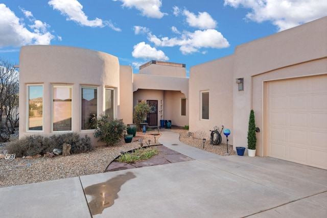 rear view of house featuring stucco siding