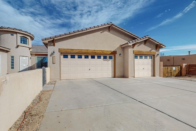 mediterranean / spanish-style house with a garage