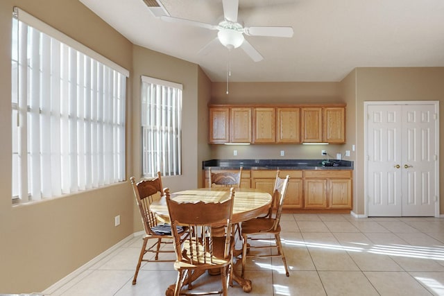 dining area with ceiling fan and light tile patterned flooring