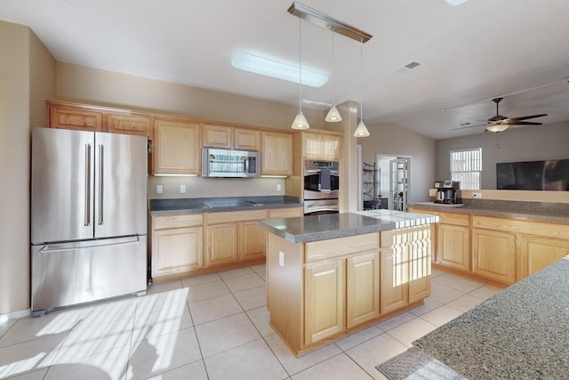 kitchen featuring appliances with stainless steel finishes, hanging light fixtures, a kitchen island, light brown cabinetry, and light tile patterned flooring