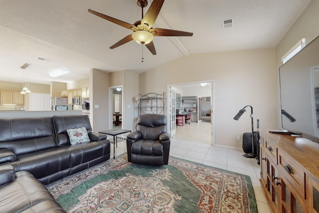 tiled living room with vaulted ceiling with beams, a textured ceiling, and ceiling fan