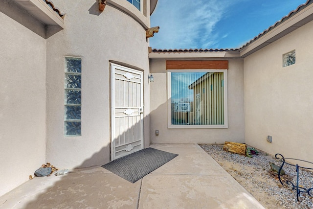 entrance to property featuring a patio area