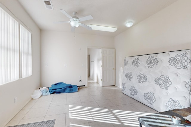 interior space with ceiling fan and light tile patterned flooring