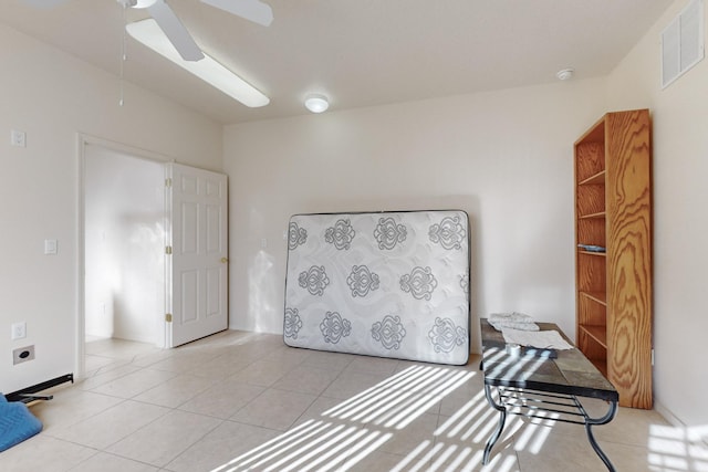 sitting room featuring light tile patterned flooring and ceiling fan