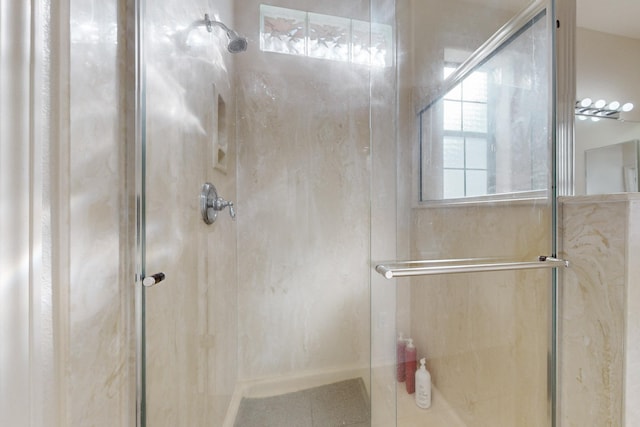 bathroom featuring a shower with shower door