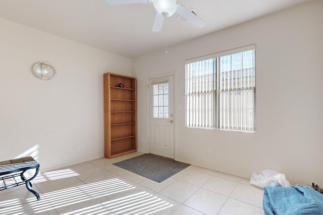 entryway with ceiling fan and light tile patterned floors