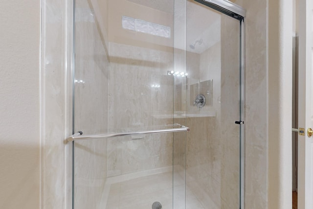 bathroom with a shower with door