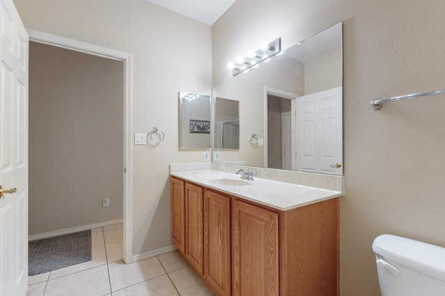 bathroom featuring vanity, tile patterned floors, and toilet