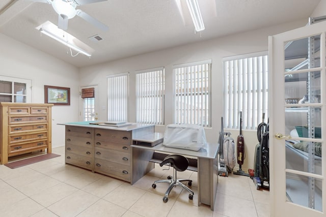 tiled home office with vaulted ceiling, a textured ceiling, and ceiling fan