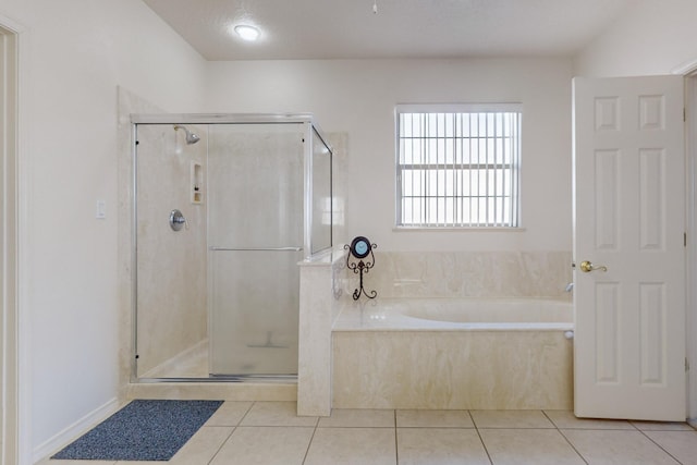 bathroom with tile patterned floors and shower with separate bathtub