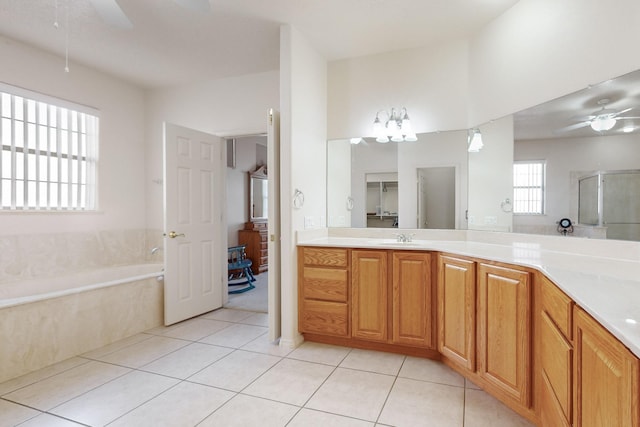 bathroom featuring ceiling fan, vanity, shower with separate bathtub, and tile patterned flooring