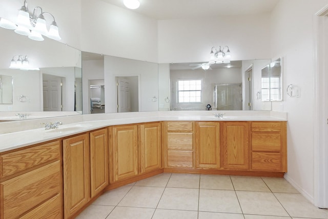 bathroom with ceiling fan, tile patterned floors, a shower with door, and vanity