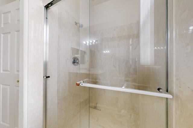 bathroom with a shower with door