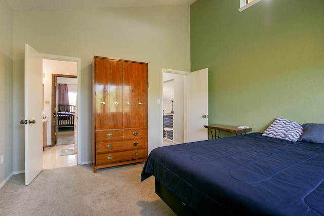 carpeted bedroom featuring a high ceiling