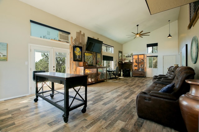 living room with hardwood / wood-style flooring, ceiling fan, and high vaulted ceiling