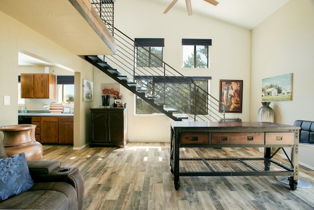 interior space featuring a wealth of natural light, hardwood / wood-style floors, ceiling fan, and high vaulted ceiling