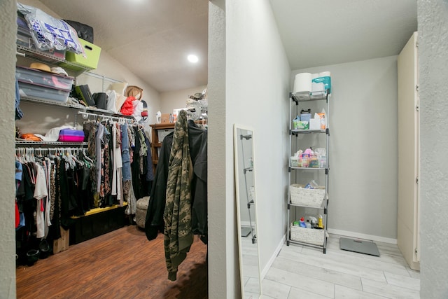 walk in closet with light hardwood / wood-style flooring