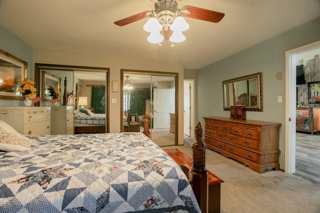 bedroom with multiple closets, ceiling fan, and light carpet